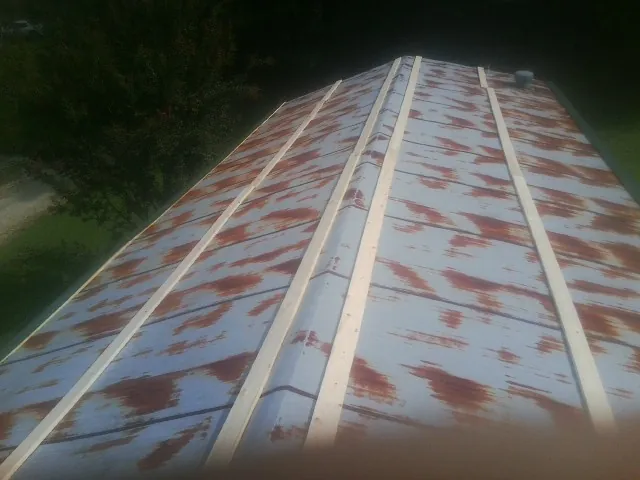 Rusted metal roof panels with new wood purlins before replacement — Storm Damage Roof Repair in Bridgeton by Roofing Brothers
