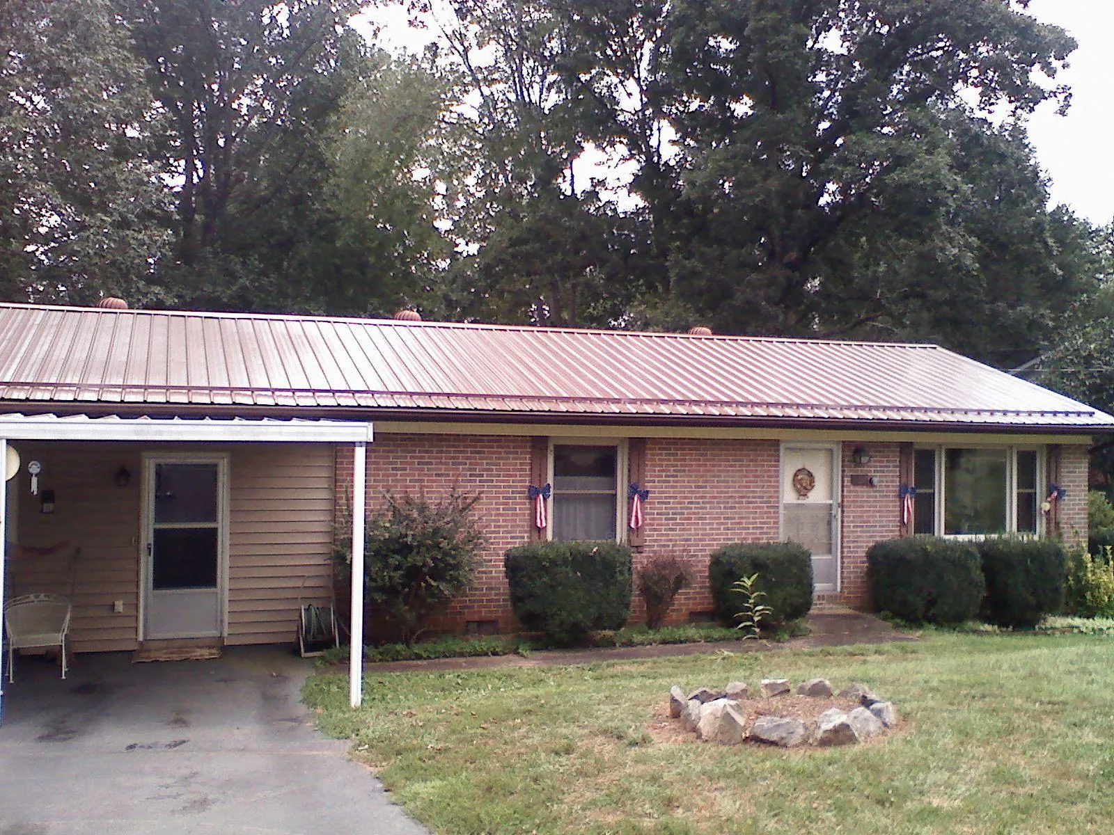 Bronze metal roof and carport on a brick ranch home — Roof Repair work by our crew in Bridgeton